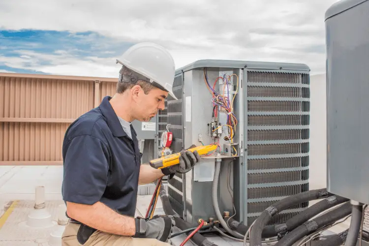 A Technician man working on a condensing unit