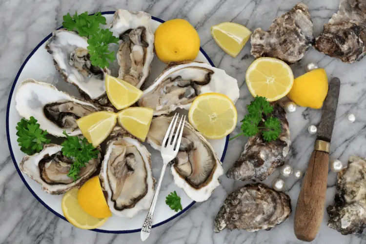 Texas oysters with lemon and peals on a marble table